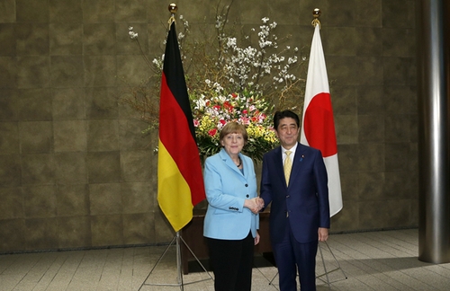3月9日，在日本東京首相官邸，日本首相安倍晉三（右）歡迎到訪的德國總理默克爾。新華社發(fā)
