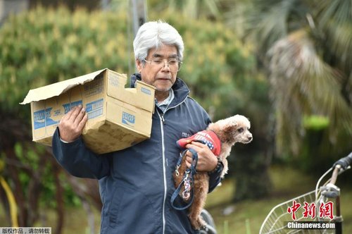 當(dāng)?shù)貢r(shí)間4月17日，一位老人抱著自己的愛犬領(lǐng)救災(zāi)物資。
