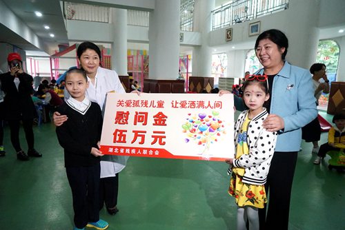 圖為省殘工委副主任、省殘聯(lián)黨組書(shū)記、理事長(zhǎng)陶慧芬委武漢市兒童福利院孤殘兒童送去慰問(wèn)金