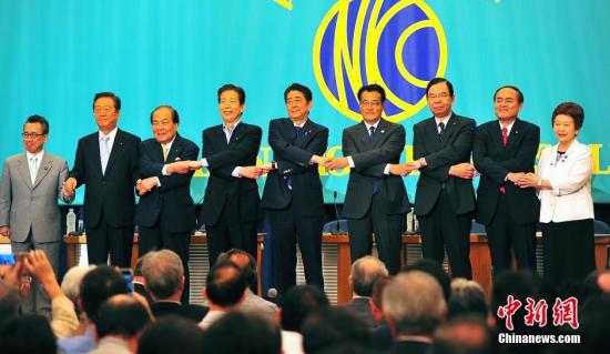 日本參議院選戰(zhàn)在即，6月21日在日本記者俱樂部進行的選前黨首辯論會上，“安倍經(jīng)濟學”的成敗功過再度成為熱辯之題。圖為與會各黨派負責人會前牽手亮相，“先禮后兵”。<a target='_blank' href='http://www.chinanews.com/'>中新社</a>記者 王健 攝