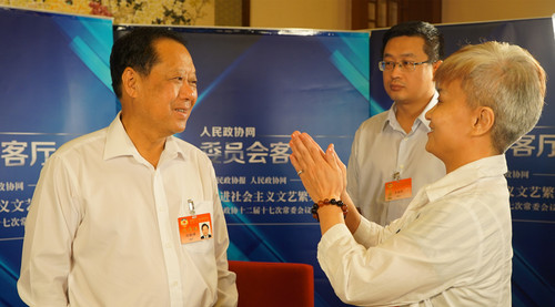 全國政協(xié)副主席劉曉峰（左一）了解報(bào)道情況