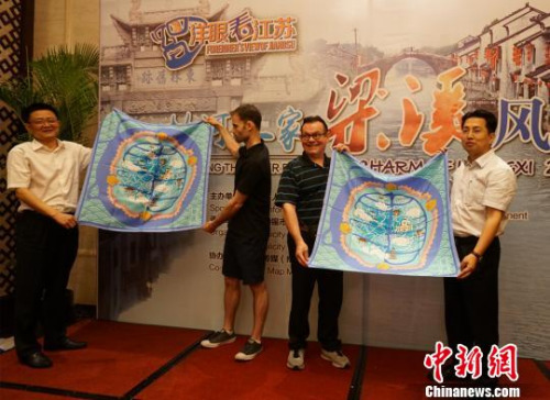 圖為無錫方面贈送手繪梁溪地圖絲巾給外籍人士代表?！O權 攝