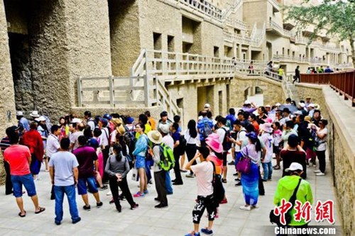 資料圖：敦煌莫高窟窟區(qū)“游人如潮”。王斌銀 攝