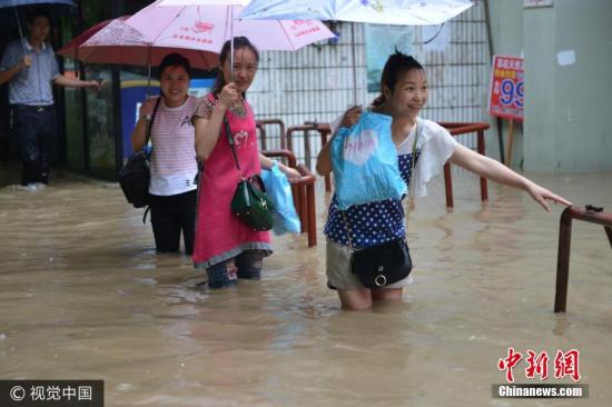 圖為南京市雨花臺(tái)區(qū)，市民在水中艱難出行。圖片來源：視覺中國(guó)
