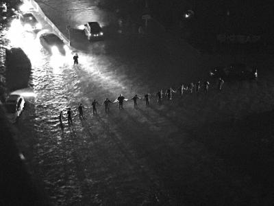 暴雨中，搶險隊員站成“人墻”，引導(dǎo)交通。劉瑜攝 
