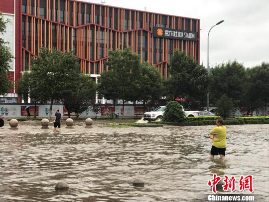 圖為24日上午河北廊坊市區(qū)街頭積水嚴重?！∷蚊魸?攝