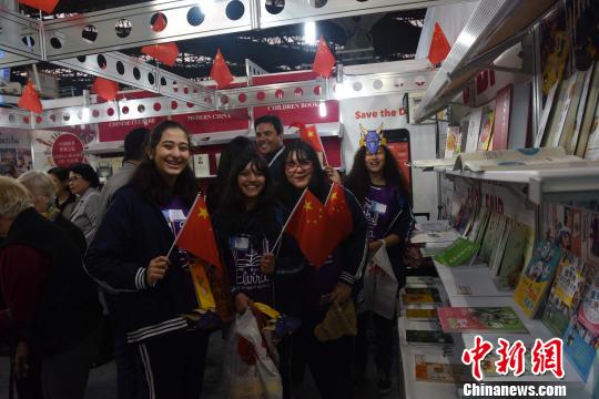 圖為巴西青年學生參觀中國圖書展臺?！∧尚?攝