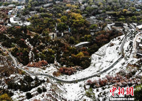 11月4日早晨，航拍視角中的蘭州城區(qū)一角，繽紛秋色中點(diǎn)綴著點(diǎn)點(diǎn)白雪。　楊艷敏 攝
