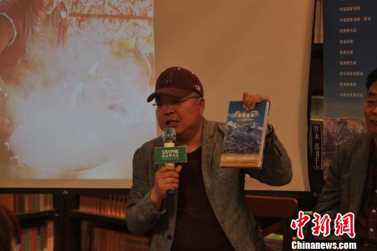 圖為西海都市報攝影部主任張海東介紹《發(fā)現(xiàn)青海100個最美觀景拍攝點》?！±钆嘣?攝