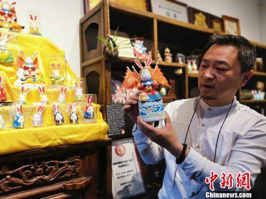 濟南泥塑“兔子王”非遺傳承人楊峰為參觀者介紹“兔子王”的文化和歷史?！≮w曉 攝
