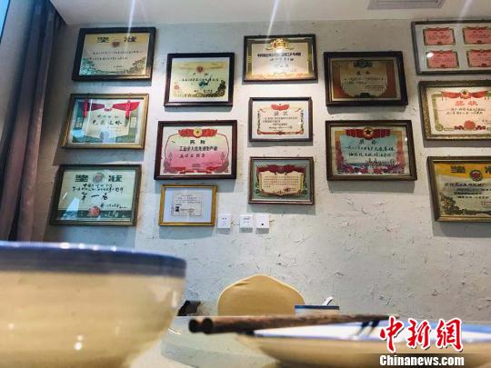 圖為“博物館餐廳”內(nèi)布設(shè)的上世紀(jì)獎(jiǎng)狀?！“瑧c龍 攝