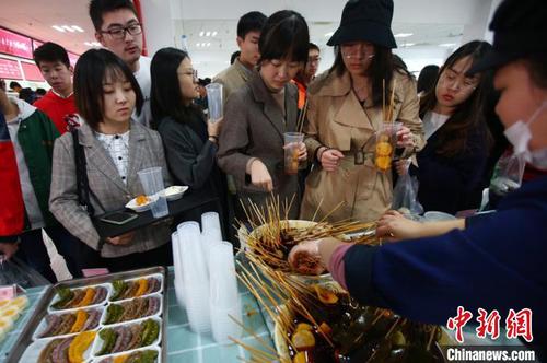 美食吸引師生們前來(lái)大快朵頤。　泱波 攝