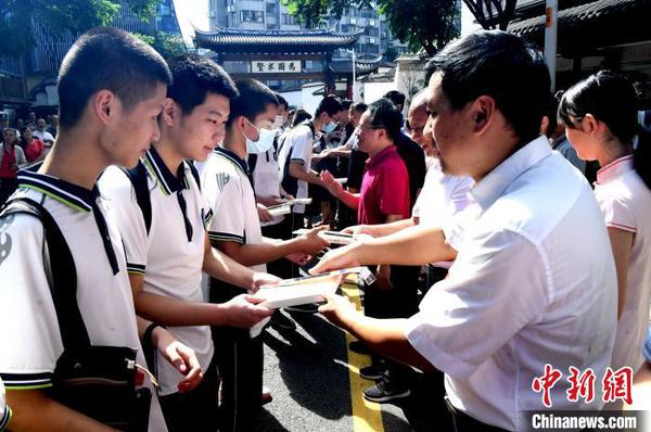 嘉賓向學子代表贈書及狀元筆。　記者劉可耕 攝